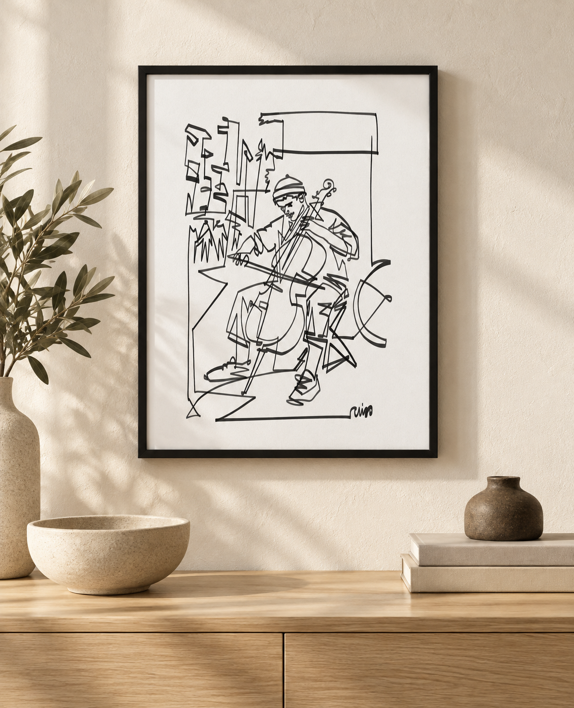 Street Cellist art print in a black frame above an oak console. Illustrative interior; frame not included.